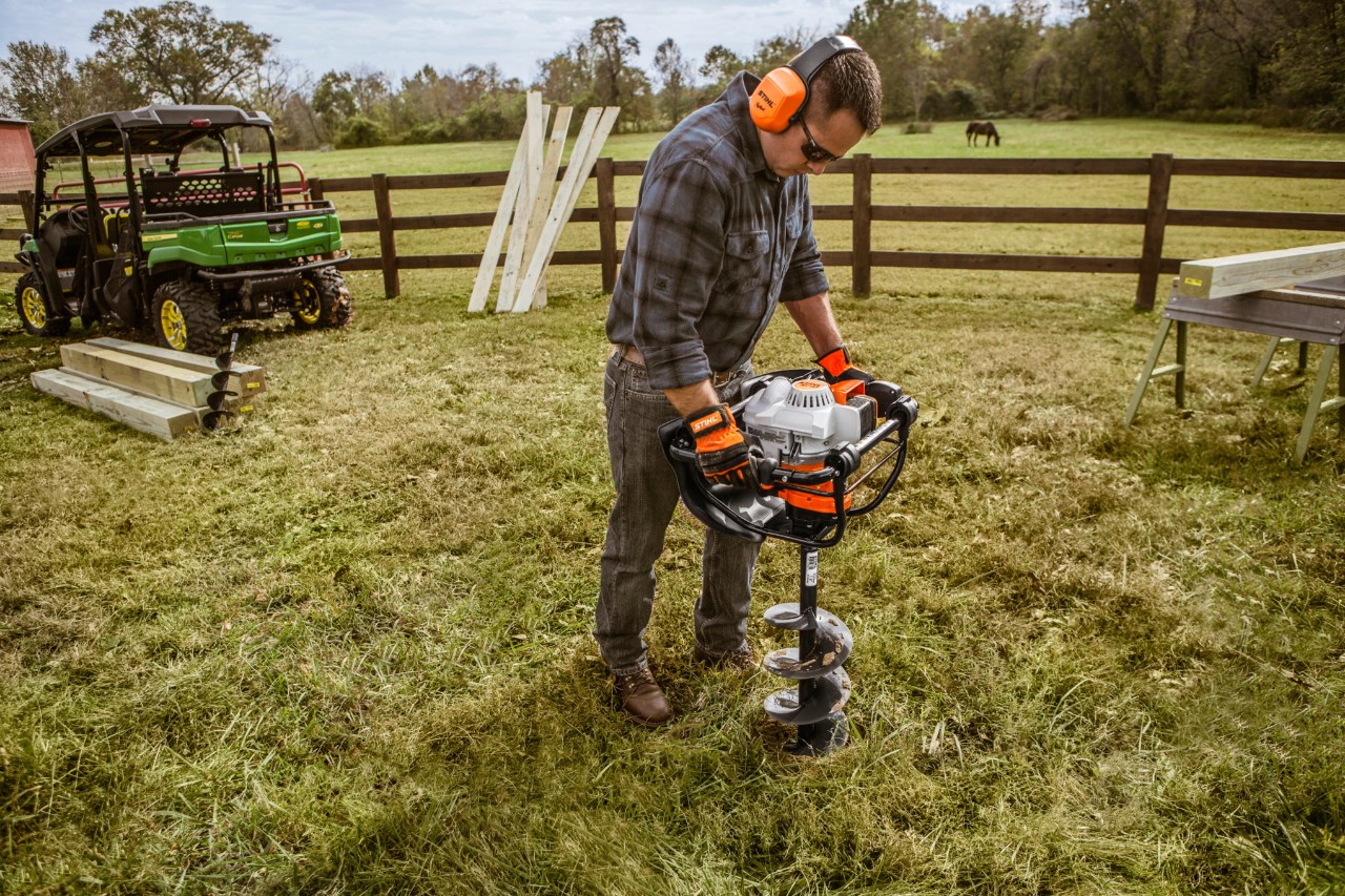 a man drilling in his farm
