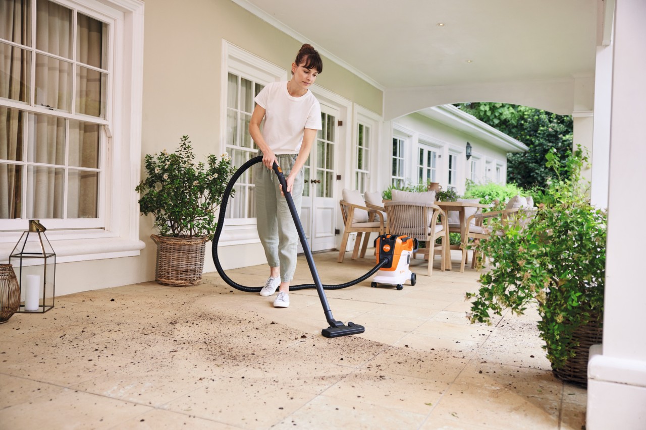 A women cleaning with vacuum cleaning
