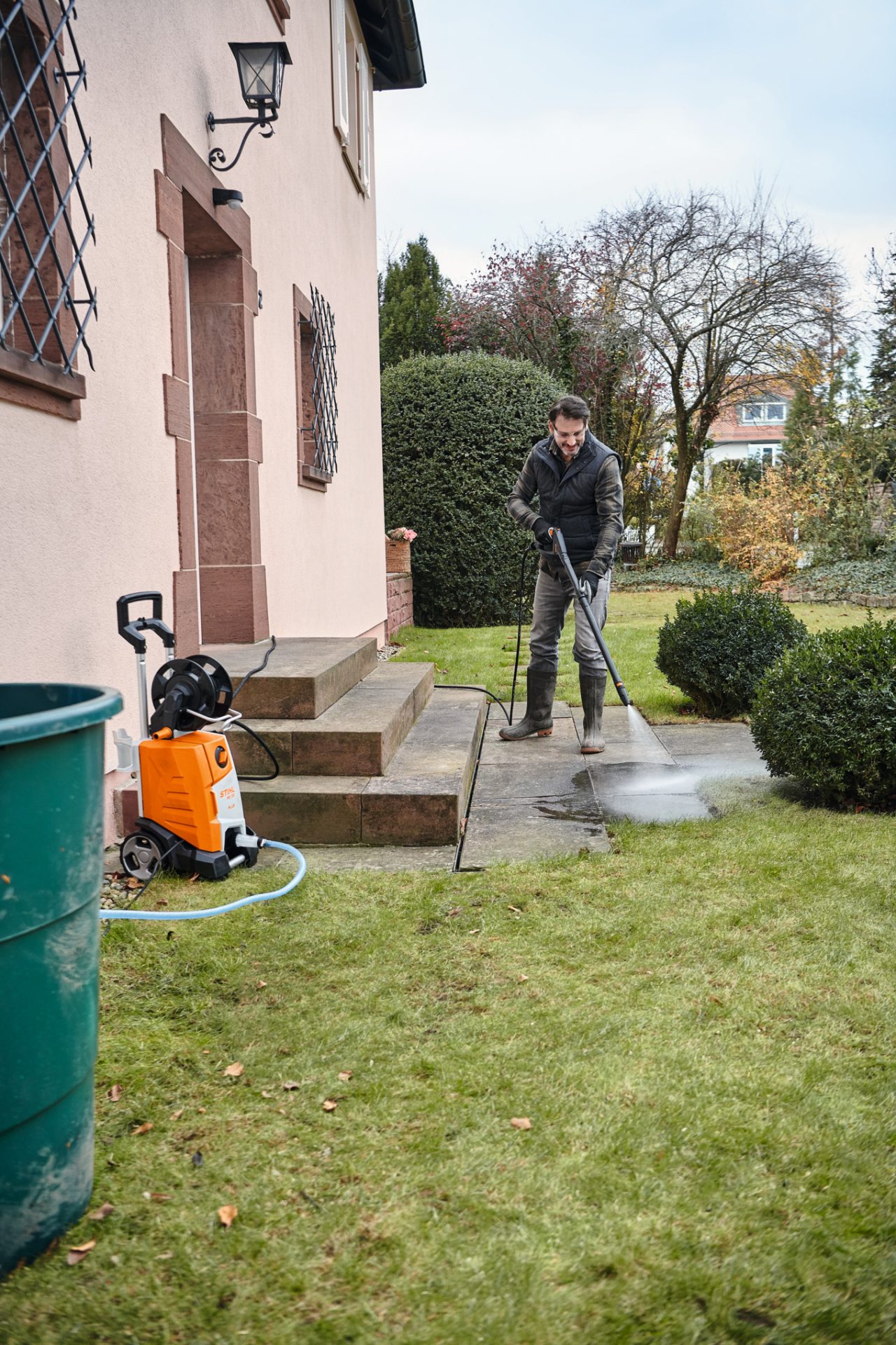 man cleaning flore with pressure washer