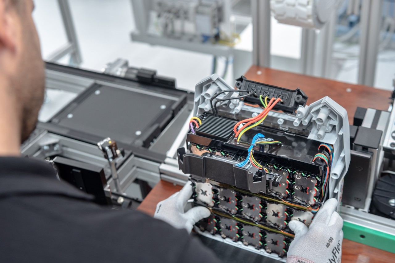 A man holding a battery for final assembly
