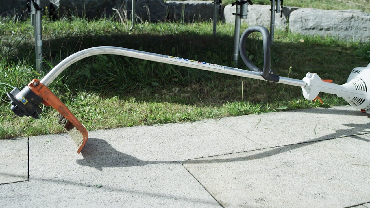 A STIHL FS 38 petrol brushcutter resting on the ground