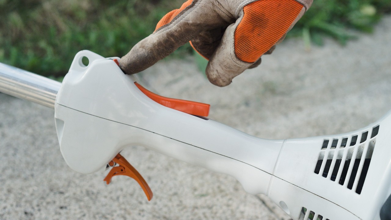 Actuating the stop switch on the STIHL FS 38 petrol brushcutter